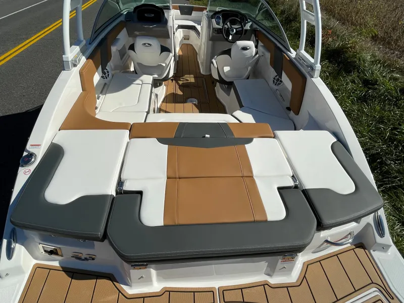 Slide: The Image of 2024 Chaparral 23 SSi OB boat interior with tan and white seating. - 44