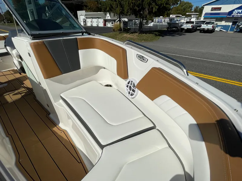 Slide: The Image of 2024 Chaparral 23 SSi OB boat interior with white and brown seating. - 9