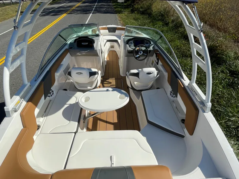 Slide: The Image of 2024 Chaparral 23 SSi OB boat interior with seating and table. - 17
