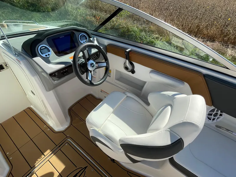 Slide: The Image of 2024 Chaparral 23 SSi OB boat cockpit with modern dashboard and comfortable seating. - 22