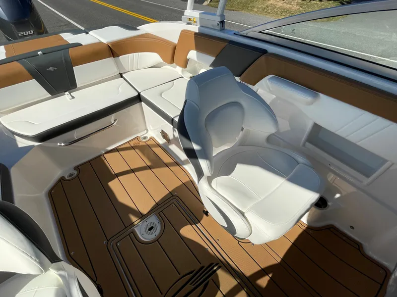Slide: The Image of 2024 Chaparral 23 SSi OB boat interior with white and tan seating. - 26