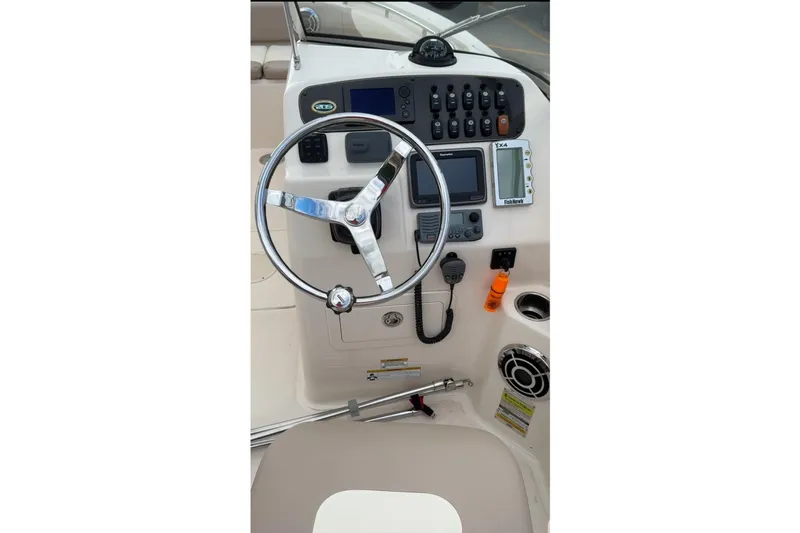 Slide: The Image of 2014 Grady-White Freedom 205 boat dashboard with steering wheel and control panel. - 10