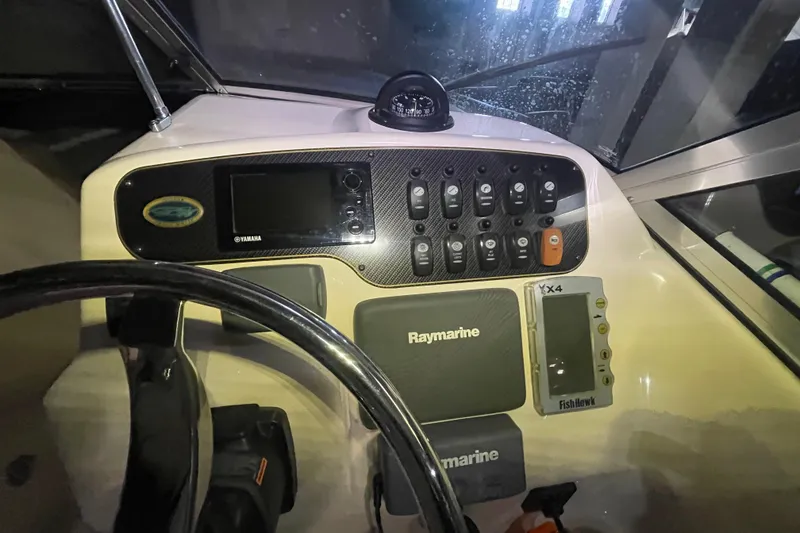 Slide: The Image of 2014 Grady-White Freedom 205 dashboard with Yamaha and Raymarine controls. - 12