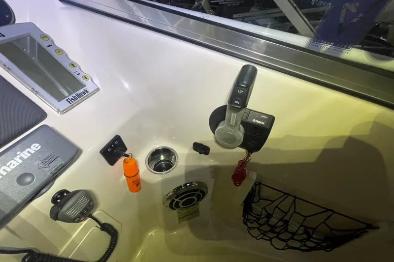 Slide: The Image of 2014 Grady-White Freedom 205 boat dashboard with Yamaha controls and marine equipment. - 13