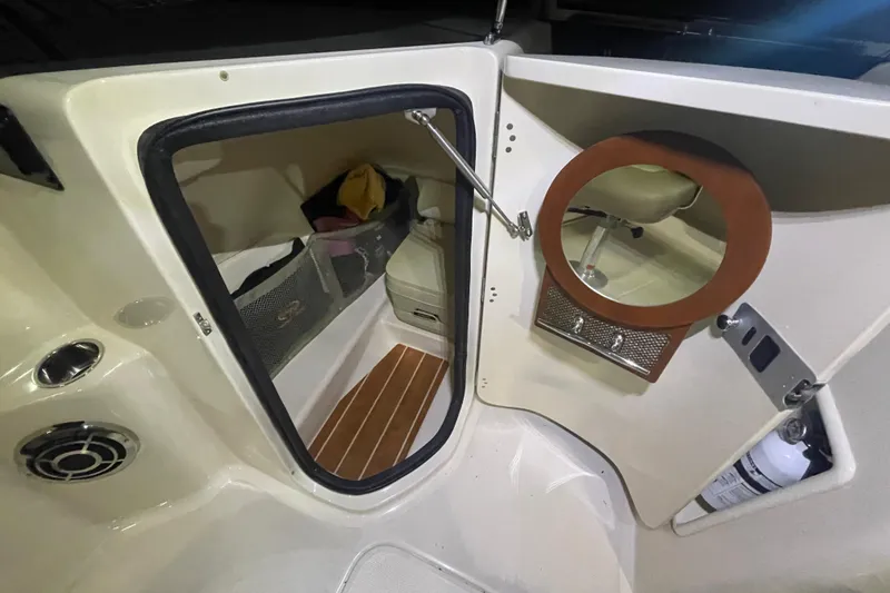 Slide: The Image of 2014 Grady-White Freedom 205 boat interior with storage and seating area. - 15
