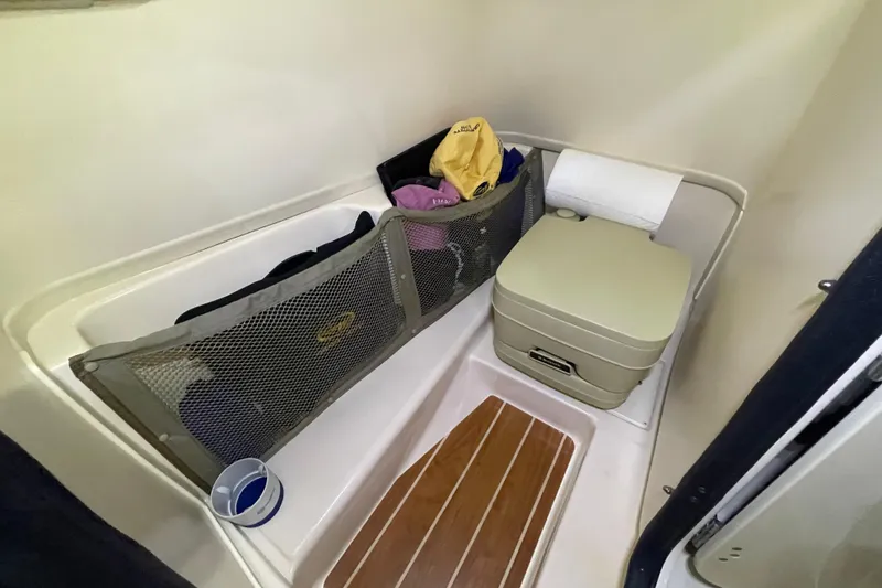 Slide: The Image of 2014 Grady-White Freedom 205 boat interior with portable toilet and storage. - 17