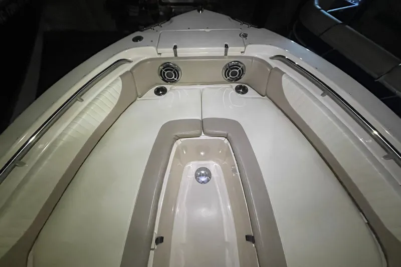 Slide: The Image of 2014 Grady-White Freedom 205 boat interior with cushioned seating and speakers. - 19