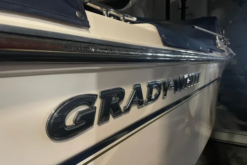 Slide: The Image of 2014 Grady-White Freedom 205 boat, close-up of logo and side view. - 23