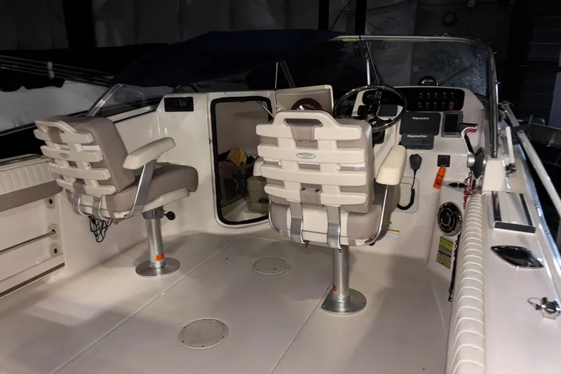 Slide: The Image of 2014 Grady-White Freedom 205 boat interior with dual seats and control panel. - 8