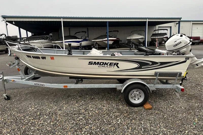 The Image of 2025 Smoker Craft 15 Alaskan Split Seat boat on a trailer, featuring Yamaha outboard motor. - 1