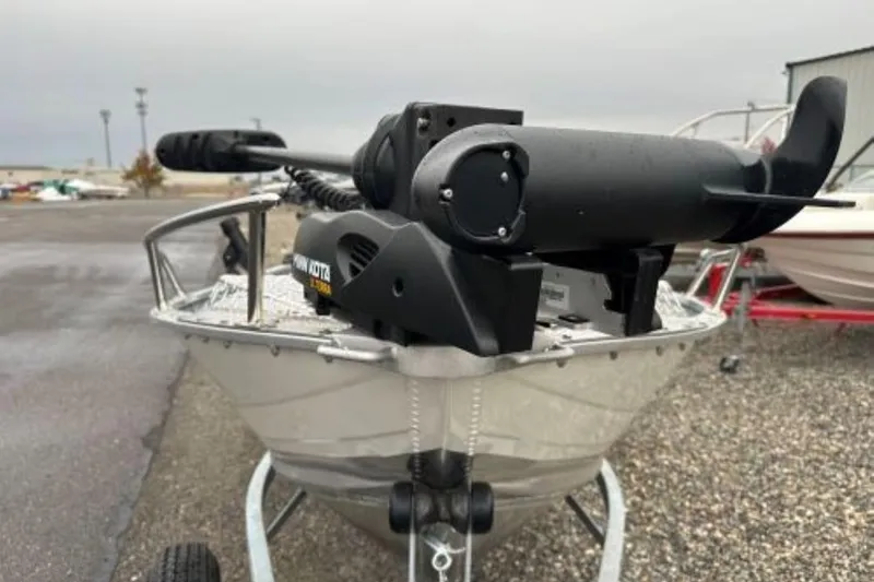 Slide: The Image of 2025 Smoker Craft 15 Alaskan Split Seat boat with motor, parked on gravel. - 3