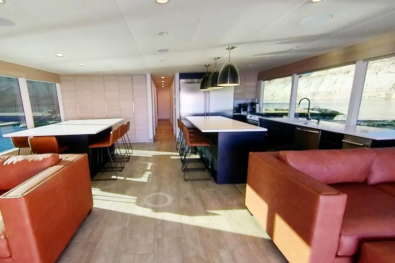 Slide: The Image of Modern houseboat interior with spacious kitchen and dining area, featuring large windows and stylish furnishings. - 4