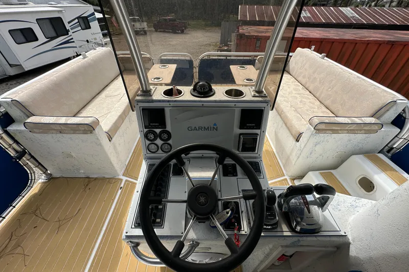 Slide: The Image of 1999 Catamaran Coaches 31 boat interior with steering wheel and Garmin navigation system. - 10