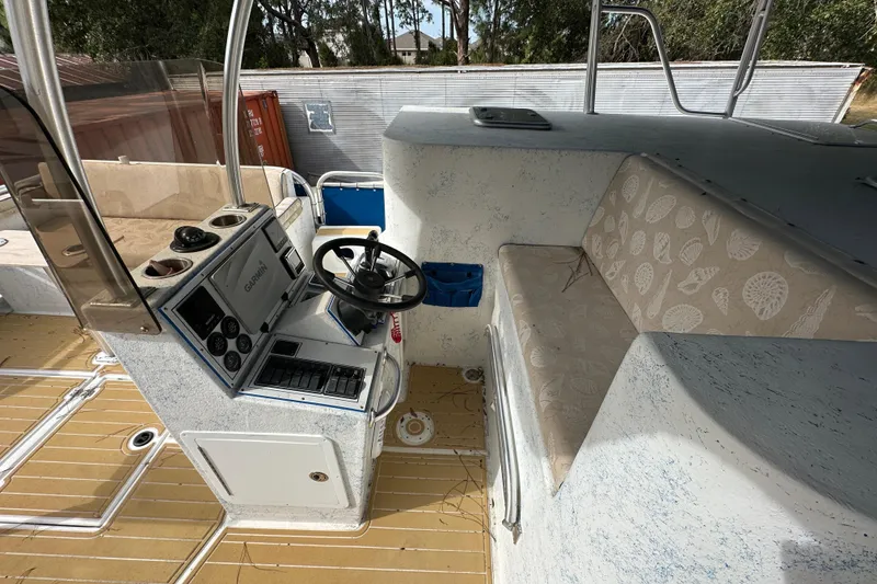 Slide: The Image of 1999 Catamaran Coaches 31 interior with steering console and cushioned seating. - 11
