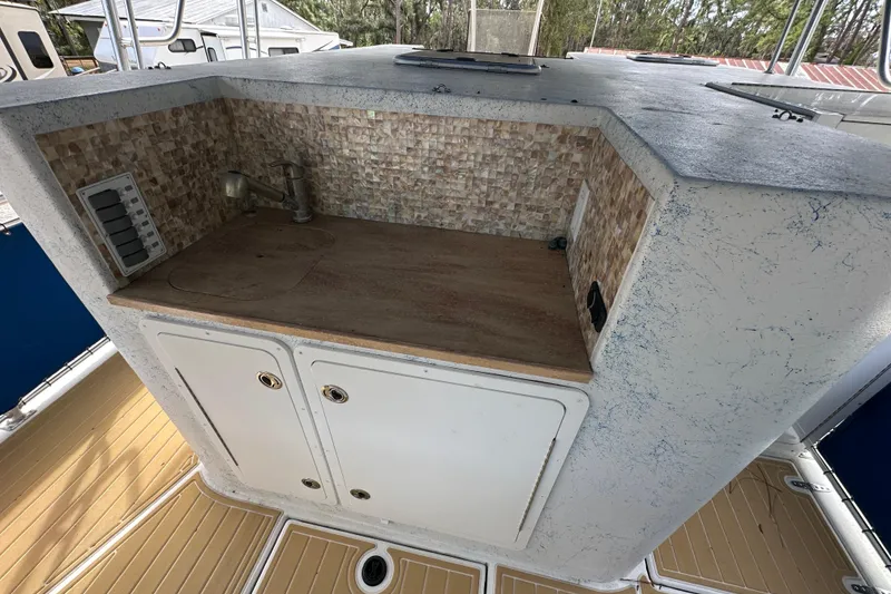 Slide: The Image of 1999 Catamaran Coaches 31 boat interior with kitchenette and storage cabinets. - 12