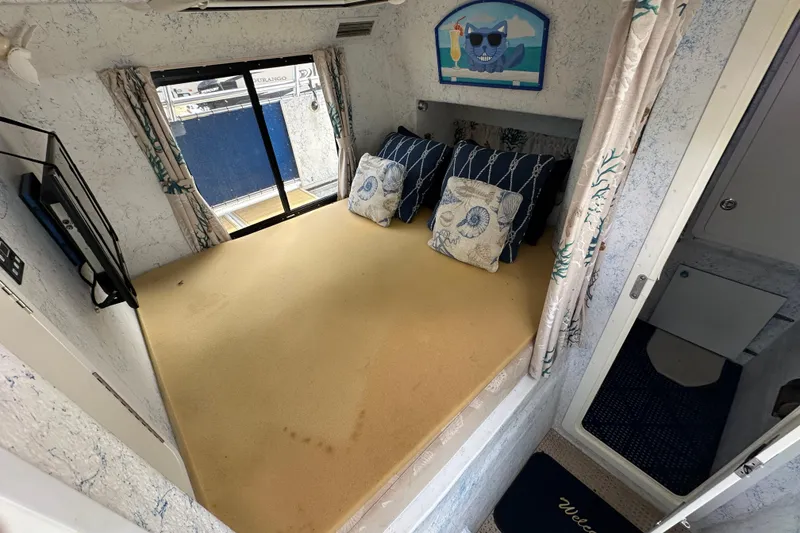 Slide: The Image of Cozy interior of 1999 Catamaran Coaches 31 with nautical-themed decor and cushions. - 13