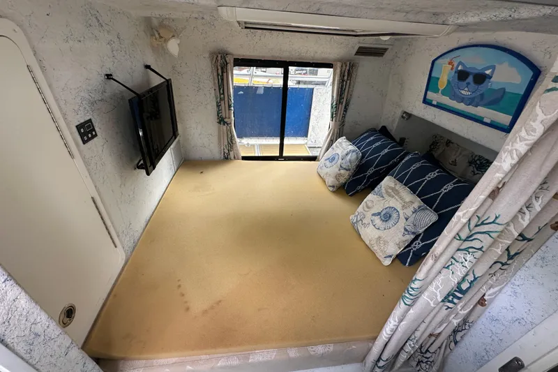 Slide: The Image of Interior of 1999 Catamaran Coaches 31 with cozy seating, pillows, and wall art. - 14