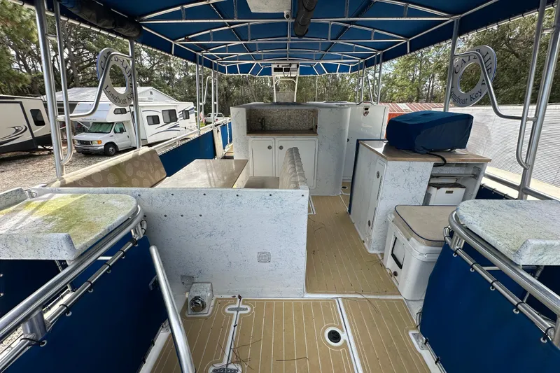Slide: The Image of 1999 Catamaran Coaches 31 interior with blue canopy, seating, and storage compartments. - 7