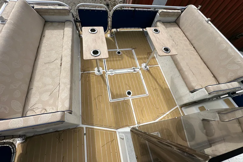 Slide: The Image of 1999 Catamaran Coaches 31 interior with beige seating and wooden deck. - 8