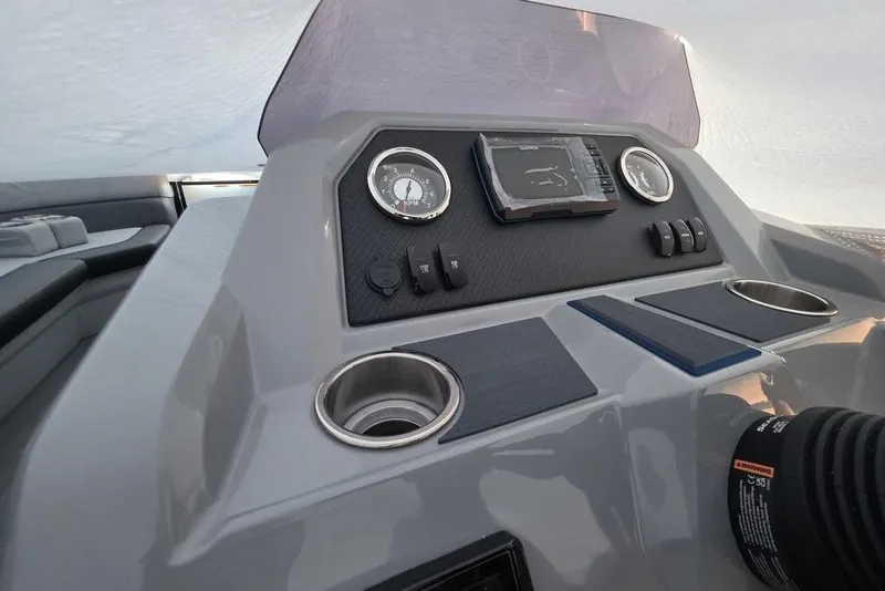 Slide: The Image of 2026 Veranda Vista 22RC boat dashboard with gauges, controls, and cup holders. - 14