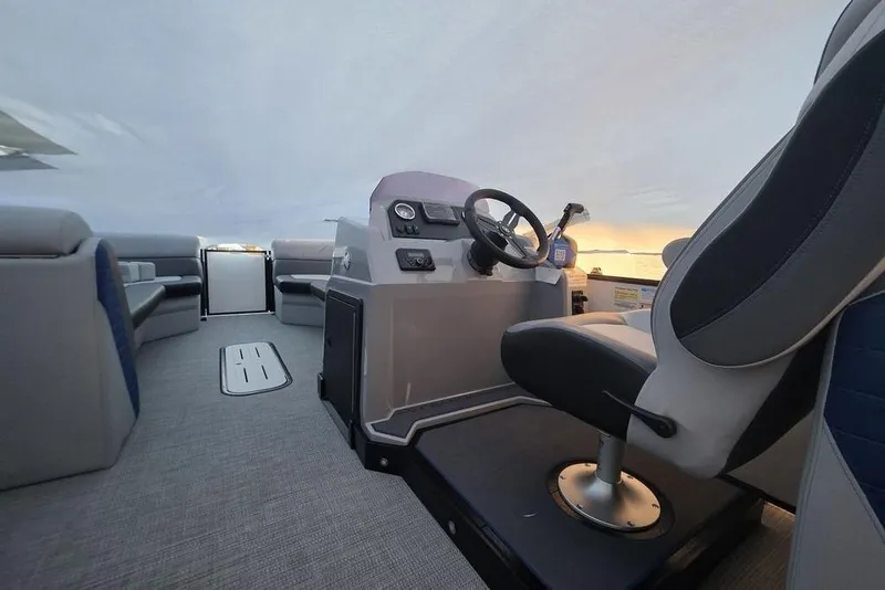 Slide: The Image of Interior of 2026 Veranda Vista 22RC pontoon boat with modern seating and steering console. - 22