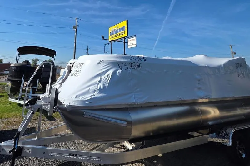 Slide: The Image of 2026 Veranda Vista 22RC pontoon boat covered on trailer at dealership. - 4