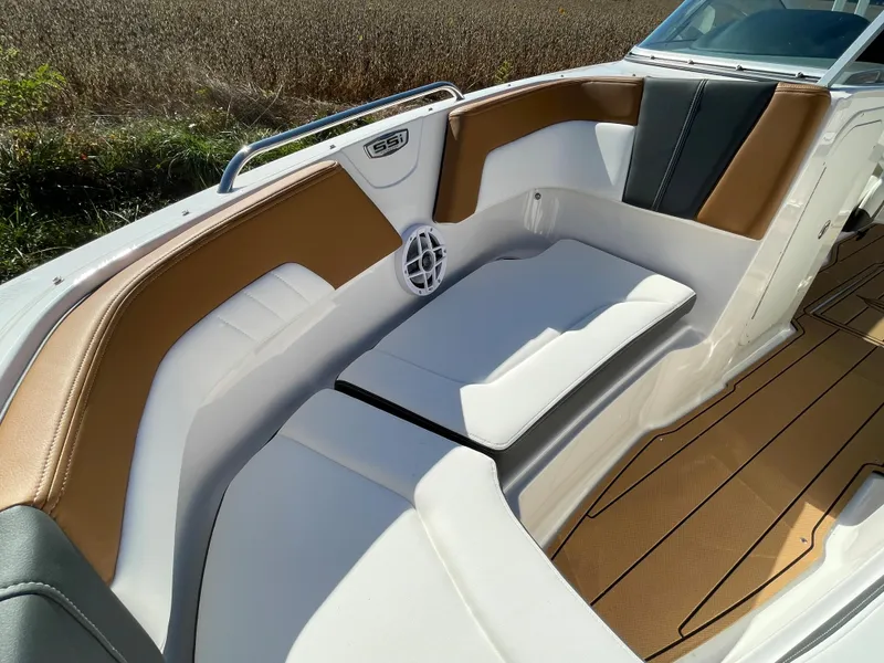 Slide: The Image of 2024 Chaparral 23 SSi OB boat interior with white and tan seating. - 10