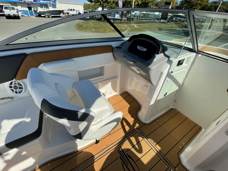 Slide: The Image of 2024 Chaparral 23 SSi OB boat interior with captain's chair and dashboard. - 25