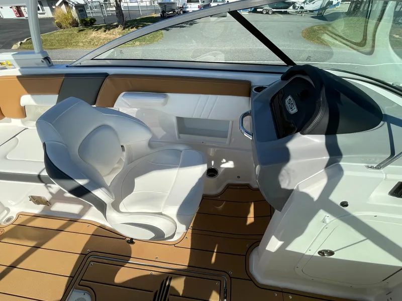 Slide: The Image of 2024 Chaparral 23 SSi OB boat interior with white seating and modern dashboard. - 27