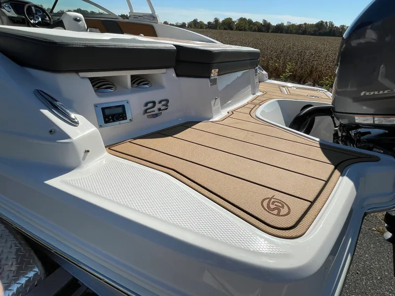 Slide: The Image of 2024 Chaparral 23 SSi OB boat deck with tan flooring and seating. - 49