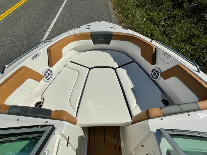 Slide: The Image of 2024 Chaparral 23 SSi OB boat interior with cushioned seating and speakers. - 5