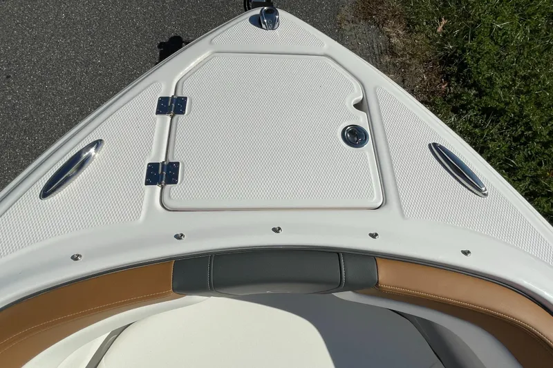 Slide: The Image of 2024 Chaparral 23 SSi OB boat bow with storage compartment and seating. - 6