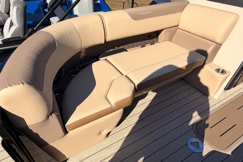 Slide: The Image of 2026 Veranda VR 235 L boat interior with beige cushioned seating and wood-style flooring. - 7