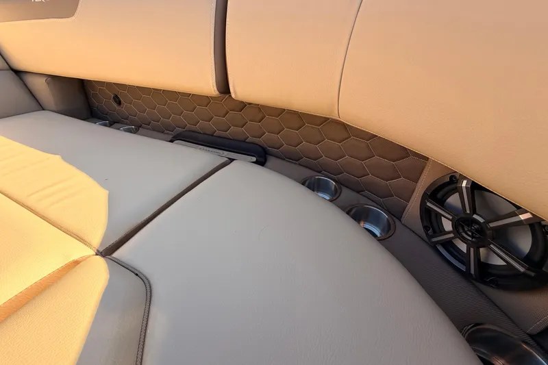 Slide: The Image of 2026 Veranda VR 235 L boat interior with beige seating, cup holders, and speaker. - 8