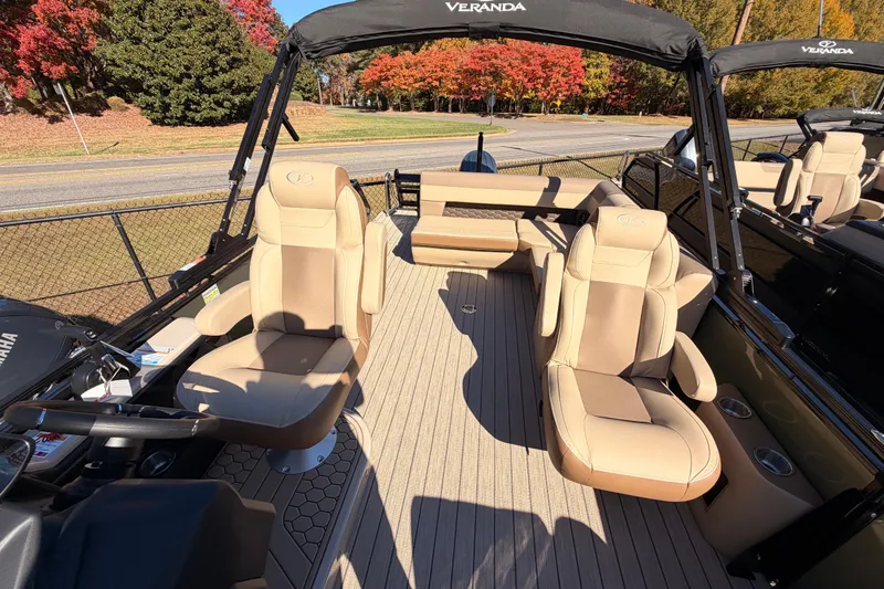Slide: The Image of 2026 Veranda VR 235 L pontoon boat interior with beige seating and steering console. - 9