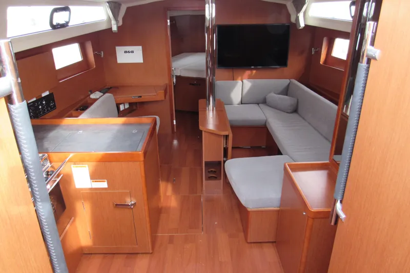 Slide: The Image of Interior of 2017 Beneteau Oceanis 41.1 yacht with modern wood finish and cozy seating. - 10