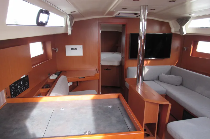 Slide: The Image of 2017 Beneteau Oceanis 41.1 yacht interior with modern furnishings and ample natural light. - 12