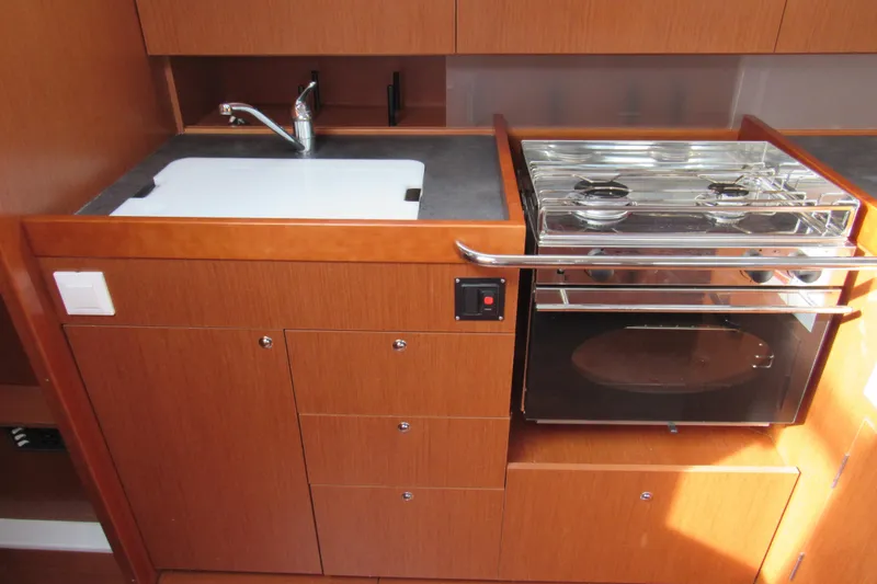 Slide: The Image of 2017 Beneteau Oceanis 41.1 yacht kitchen with sink and stove. - 14