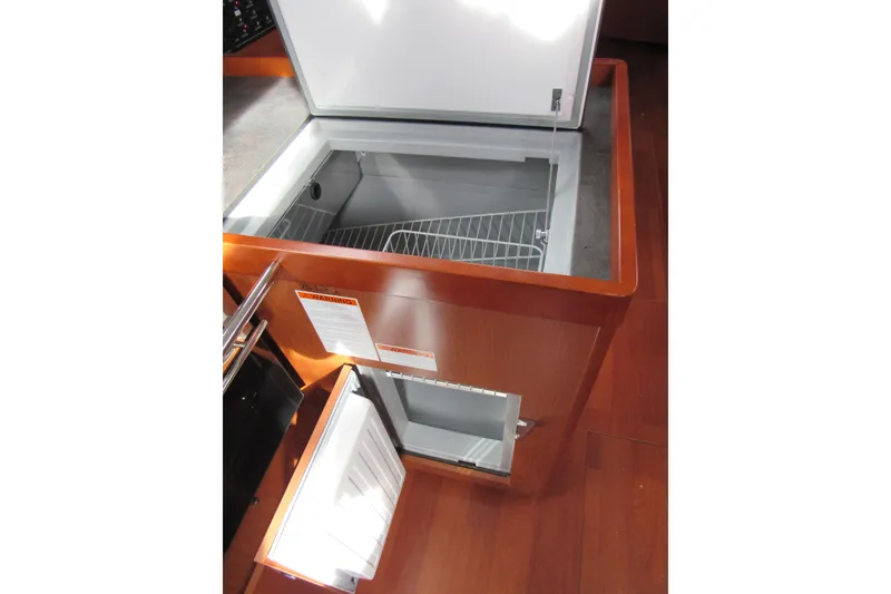 Slide: The Image of 2017 Beneteau Oceanis 41.1 yacht interior with open refrigerator and freezer. - 15