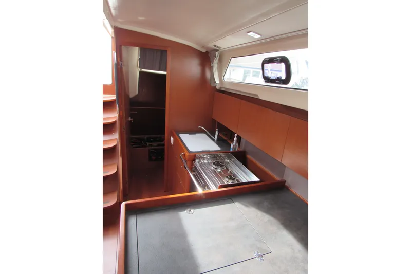 Slide: The Image of 2017 Beneteau Oceanis 41.1 yacht interior with modern kitchen and wooden cabinetry. - 16