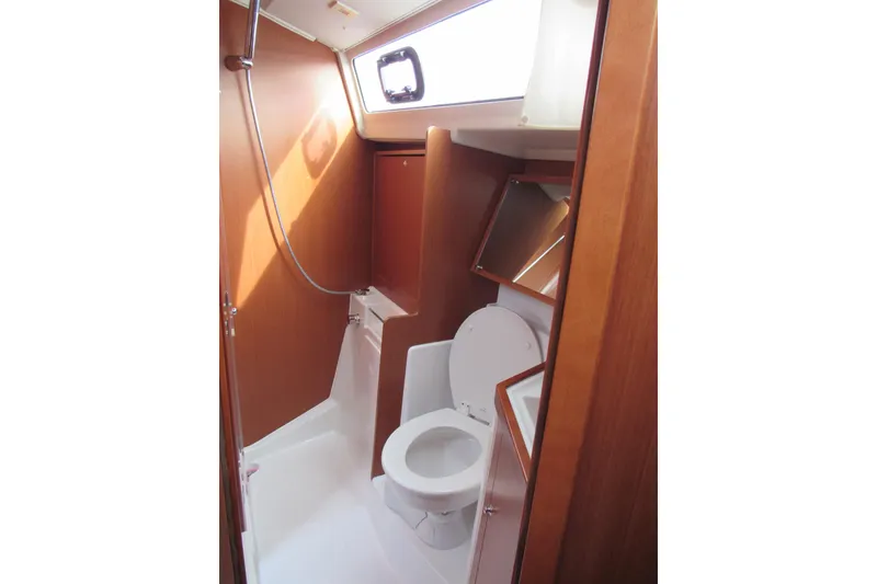 Slide: The Image of 2017 Beneteau Oceanis 41.1 yacht bathroom with wooden cabinetry and modern fixtures. - 20