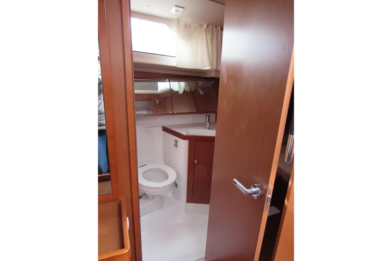 Slide: The Image of 2017 Beneteau Oceanis 41.1 yacht bathroom with wooden cabinetry and modern fixtures. - 21