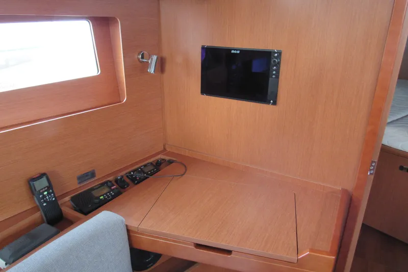 Slide: The Image of Navigation station in 2017 Beneteau Oceanis 41.1 yacht with wood finish and electronic equipment. - 22