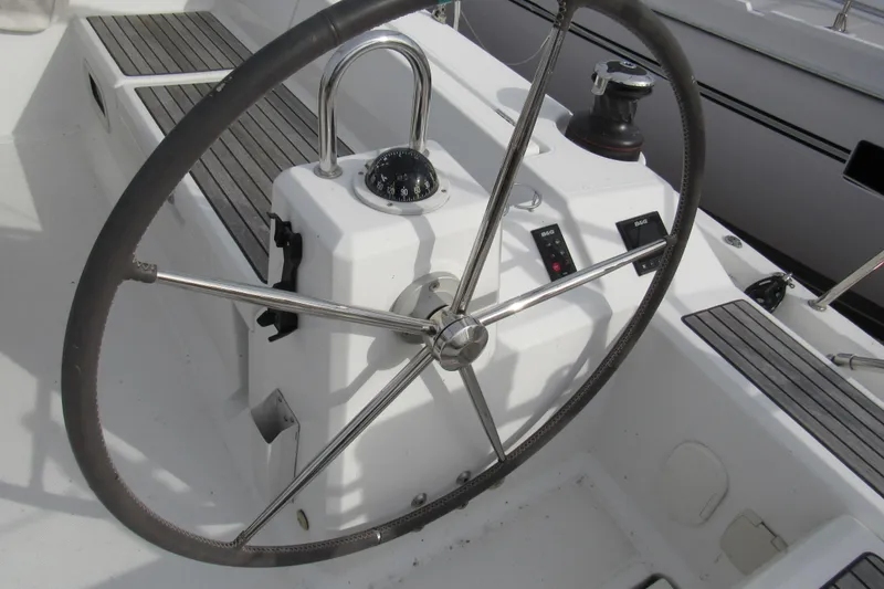 Slide: The Image of Steering wheel of 2017 Beneteau Oceanis 41.1 sailboat with compass and controls. - 31