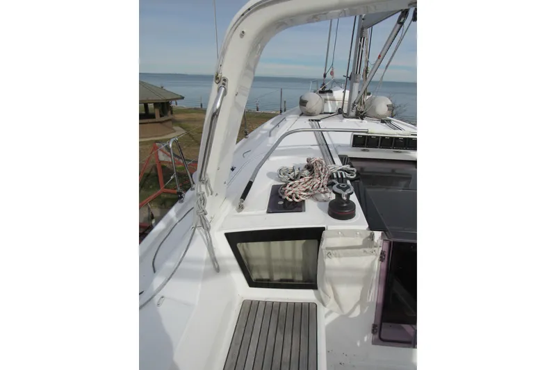 Slide: The Image of 2017 Beneteau Oceanis 41.1 yacht deck with ropes and winch, near the sea. - 33