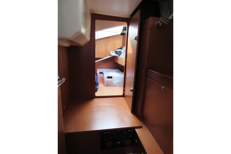 Slide: The Image of Interior cabin of 2017 Beneteau Oceanis 41.1 yacht, featuring wooden furnishings and storage space. - 48