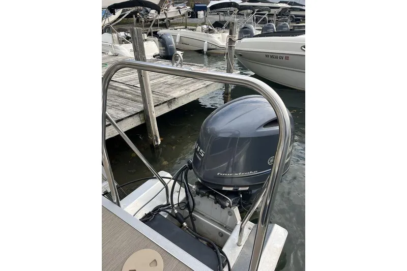 Slide: The Image of 2018 Bennington 23SLX boat with Yamaha outboard motor docked at marina. - 10