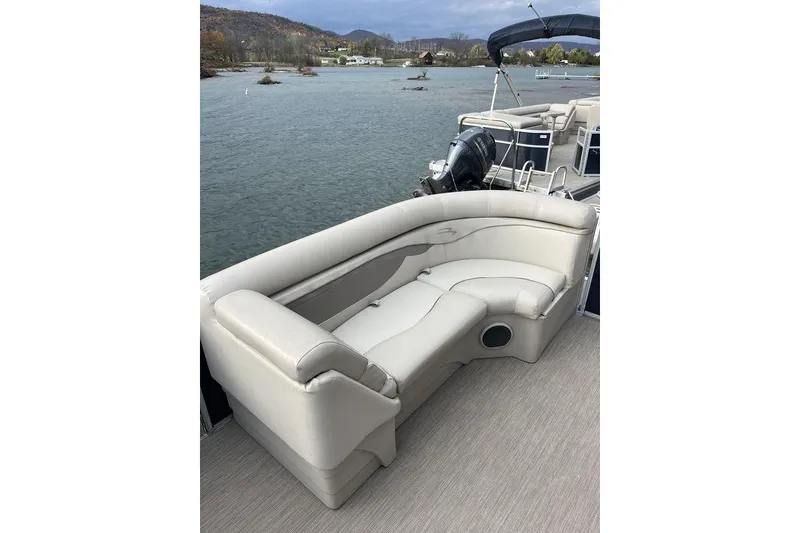 Slide: The Image of 2018 Bennington 23SLX pontoon boat with beige seating, on a scenic lake. - 12