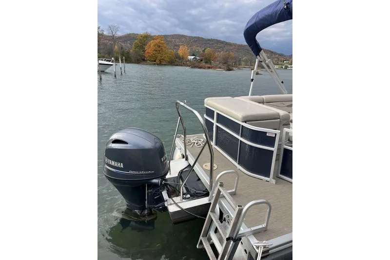Slide: The Image of 2018 Bennington 23SLX pontoon boat with Yamaha motor on a scenic lake. - 3