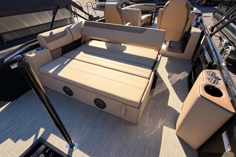 Slide: The Image of 2026 Veranda VR235VL pontoon boat interior with beige seating and cup holders. - 14